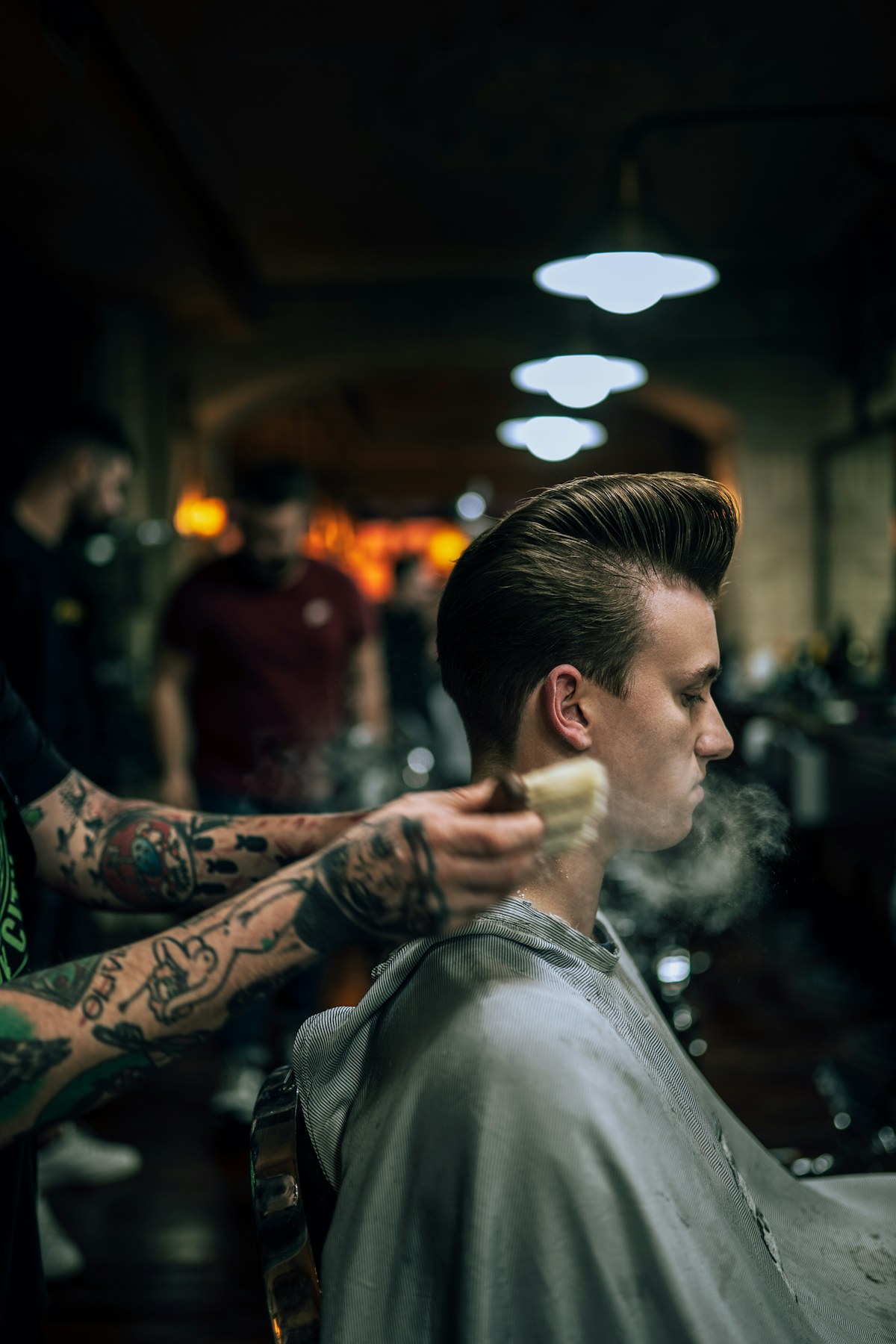 A client relaxing while a barber works