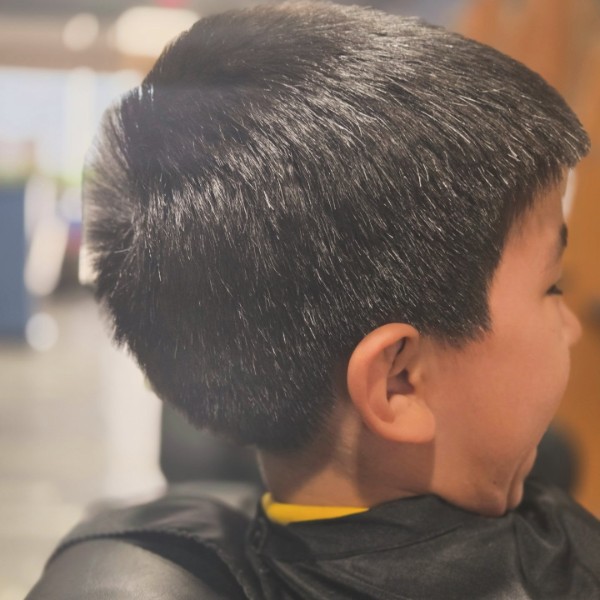 Side view of a finished kids adventure cut with a softly tapered neckline