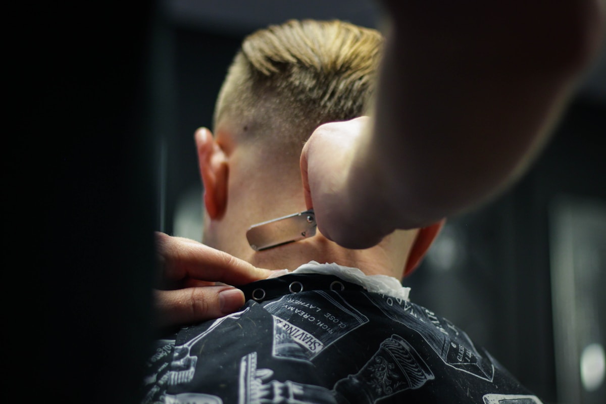 Close-up of precise razor detailing during a haircut