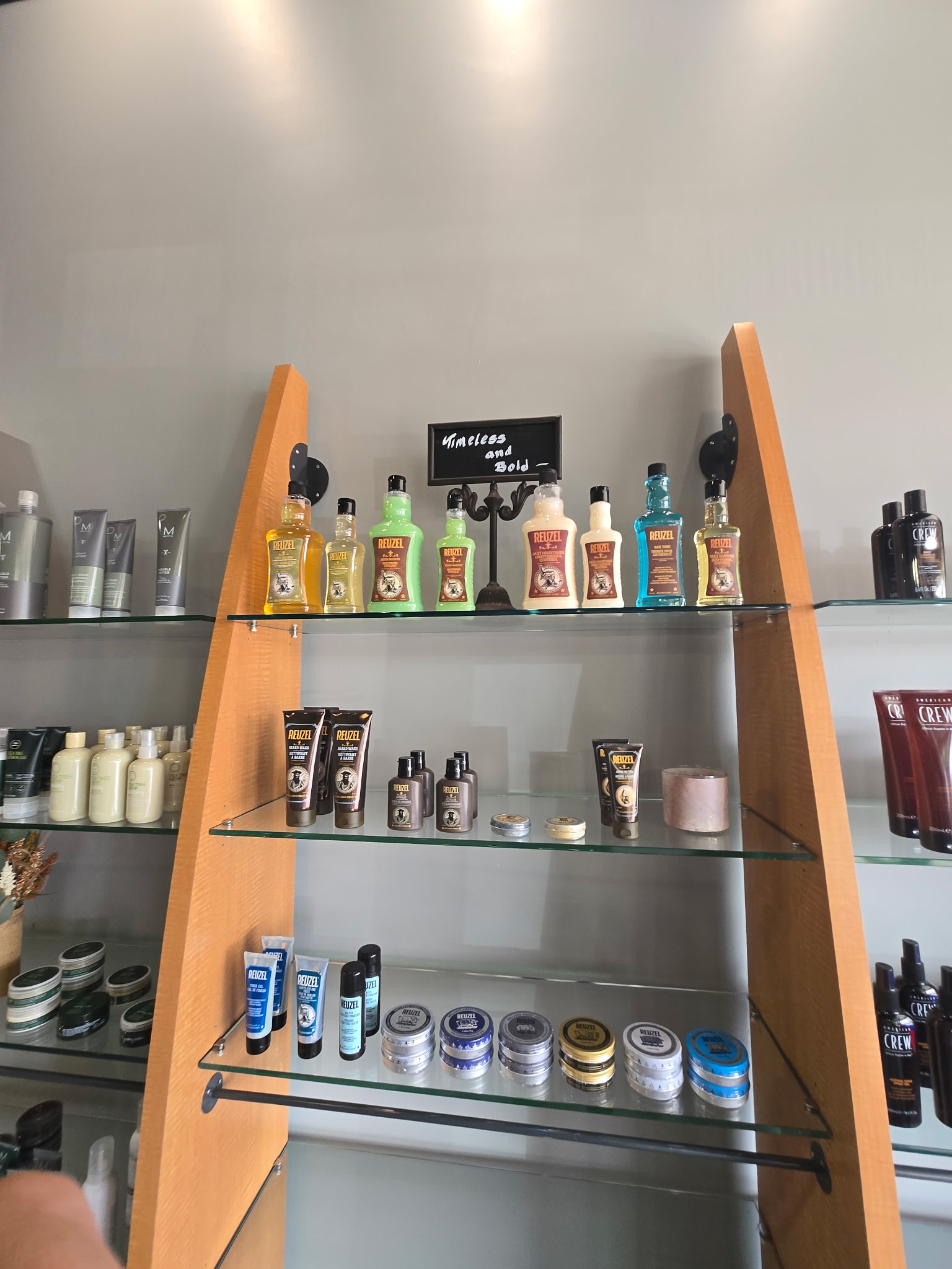 Reuzel grooming and styling products arranged on the salon display